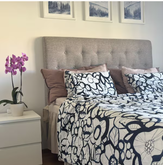 Blue Misty Mountains print set hung above a bed — buyer photo